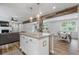 Open layout: kitchen with granite island, stainless appliances, and a view of living and dining areas at 2109 Allgood Rd, Marietta, GA 30062