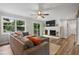 Inviting living area with a cozy fireplace, hardwood floors, and sliding door access to the deck at 2109 Allgood Rd, Marietta, GA 30062