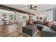 Spacious living area featuring hardwood floors, rustic beam, and an open layout to the kitchen at 2109 Allgood Rd, Marietta, GA 30062