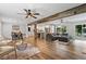 Open-concept living space featuring hardwood floors, a rustic beam, and seamless flow to the kitchen at 2109 Allgood Rd, Marietta, GA 30062