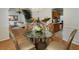 Charming dining area with a glass table, chandelier, and a view to the living room and kitchen at 2833 Golden Club Bnd, Austell, GA 30106