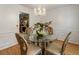 Cozy dining room with a glass table, chandelier, and a view to the kitchen showcasing natural light at 2833 Golden Club Bnd, Austell, GA 30106