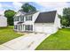Two-story home with a two-car garage and a lush green lawn at 2833 Golden Club Bnd, Austell, GA 30106