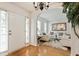 Bright foyer with hardwood floors leading to a living room with white furniture at 2833 Golden Club Bnd, Austell, GA 30106