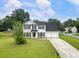 Charming two-story home featuring a well-manicured lawn and a two-car garage at 2833 Golden Club Bnd, Austell, GA 30106