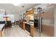 Charming kitchen with stainless steel refrigerator, wooden cabinets, and tiled floor at 2833 Golden Club Bnd, Austell, GA 30106
