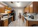 Efficient kitchen with wooden cabinets, white counters, and a view to the dining area at 2833 Golden Club Bnd, Austell, GA 30106