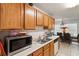 Kitchen with wooden cabinets, a microwave, and a view to the dining area with natural lighting at 2833 Golden Club Bnd, Austell, GA 30106