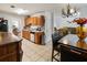 Open kitchen featuring tiled floors, wood cabinets, and a view to the dining and living areas at 2833 Golden Club Bnd, Austell, GA 30106