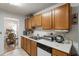 Cozy kitchen with wooden cabinets, white counters, and a view to the dining area at 2833 Golden Club Bnd, Austell, GA 30106