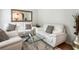 Bright living room featuring elegant white sofas, plush rug, mirrored wall decor and stylish glass coffee table at 2833 Golden Club Bnd, Austell, GA 30106