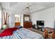Spacious main bedroom featuring fan, carpeted floors, and open bathroom at 2833 Golden Club Bnd, Austell, GA 30106