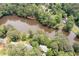 Scenic aerial view of a lake surrounded by lush green trees, showcasing waterfront property at 4920 Hampton Lake Dr, Marietta, GA 30068