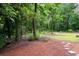 A large lot with mature trees and wood chip ground covering at 4920 Hampton Lake Dr, Marietta, GA 30068