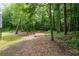 Large backyard with mature trees, providing shade and a natural aesthetic at 4920 Hampton Lake Dr, Marietta, GA 30068
