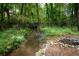 There is a small creek and some interesting water features in the backyard at 4920 Hampton Lake Dr, Marietta, GA 30068