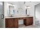 Bathroom with dark wood cabinetry, double sinks, and a stylish decorative mirror at 4920 Hampton Lake Dr, Marietta, GA 30068