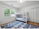 Cozy bedroom featuring a bunk bed, colorful rug and a window with natural light at 4920 Hampton Lake Dr, Marietta, GA 30068