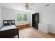 Well-lit bedroom with modern furnishings, hardwood floors, and backyard views at 4920 Hampton Lake Dr, Marietta, GA 30068