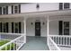 Elegant front porch with decorative railings and a stylish front door, enhancing curb appeal at 4920 Hampton Lake Dr, Marietta, GA 30068