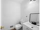 Clean half bathroom featuring white fixtures, modern sink, and wood-look flooring at 4920 Hampton Lake Dr, Marietta, GA 30068