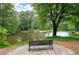 Relaxing view of a lake from a bench, showing the home's serene outdoor space at 4920 Hampton Lake Dr, Marietta, GA 30068