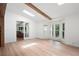 Bright living room with skylights and windows, featuring hardwood floors and open access to porch at 4920 Hampton Lake Dr, Marietta, GA 30068