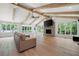 Open living room featuring vaulted ceilings, wood beams and a stone fireplace at 4920 Hampton Lake Dr, Marietta, GA 30068