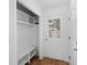 Bright mudroom with bench, shelving, and an exterior door at 4920 Hampton Lake Dr, Marietta, GA 30068