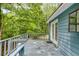 Back deck looks out over an area of trees, green foliage, and plants at 4985 Watkins Ct, Winston, GA 30187