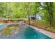 Backyard featuring a covered pool and natural foliage at 4985 Watkins Ct, Winston, GA 30187