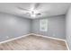Spacious bedroom with light gray walls, light-colored floors, and a ceiling fan at 4985 Watkins Ct, Winston, GA 30187