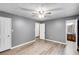 Spacious bedroom with ceiling fan, updated flooring and adjacent bathroom at 4985 Watkins Ct, Winston, GA 30187