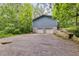 Rear exterior featuring a 2 car garage with light blue siding and driveway at 4985 Watkins Ct, Winston, GA 30187