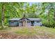 Charming single story home featuring a stone chimney and situated on a tree-lined lot at 4985 Watkins Ct, Winston, GA 30187