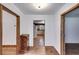 View of the home's hallway featuring hardwood floors and rustic wood door frames at 4985 Watkins Ct, Winston, GA 30187