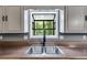 Close up of the kitchen sink and window with stainless steel basin at 4985 Watkins Ct, Winston, GA 30187