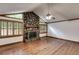 Cozy living room featuring a stone fireplace, hardwood floors and wood-trimmed windows at 4985 Watkins Ct, Winston, GA 30187