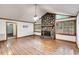 Spacious living room featuring a stone fireplace, hardwood floors, and wood-trimmed windows at 4985 Watkins Ct, Winston, GA 30187