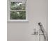 An interior view of a window looking out to leafy trees, plants, and green foliage at 4985 Watkins Ct, Winston, GA 30187