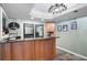 Stylish basement bar with a granite countertop, wood cabinetry, mirrors, and tasteful decor at 206 Kingsley Way, Woodstock, GA 30188