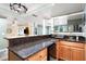 Well-appointed bar features counter seating, wooden cabinets, sleek countertops, and easy access to other basement amenities at 206 Kingsley Way, Woodstock, GA 30188
