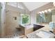 Primary bathroom featuring glass shower, soaking tub, granite counters, and stylish tile flooring at 206 Kingsley Way, Woodstock, GA 30188