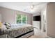 Well-lit bedroom with ceiling fan, a neutral color scheme, and large window overlooking the yard at 206 Kingsley Way, Woodstock, GA 30188