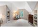 Cozy bedroom features vaulted ceiling, large window, carpeted floor and built-in shelving for storage at 206 Kingsley Way, Woodstock, GA 30188