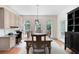Bright dining area featuring hardwood floors, modern lighting, access to the back deck, and custom cabinet at 206 Kingsley Way, Woodstock, GA 30188