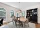 Well-lit dining room with modern chandelier, deck access, hardwood floors, and custom built-in shelves at 206 Kingsley Way, Woodstock, GA 30188