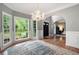 Open dining area with beautiful hardwood flooring, decorative chandelier, and bay windows for natural light at 206 Kingsley Way, Woodstock, GA 30188