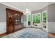 Bright dining room with a crystal chandelier, hardwood floors, large windows, and a vintage china cabinet at 206 Kingsley Way, Woodstock, GA 30188