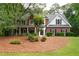 Charming brick home with lush landscaping, inviting front porch and a well-manicured lawn at 206 Kingsley Way, Woodstock, GA 30188